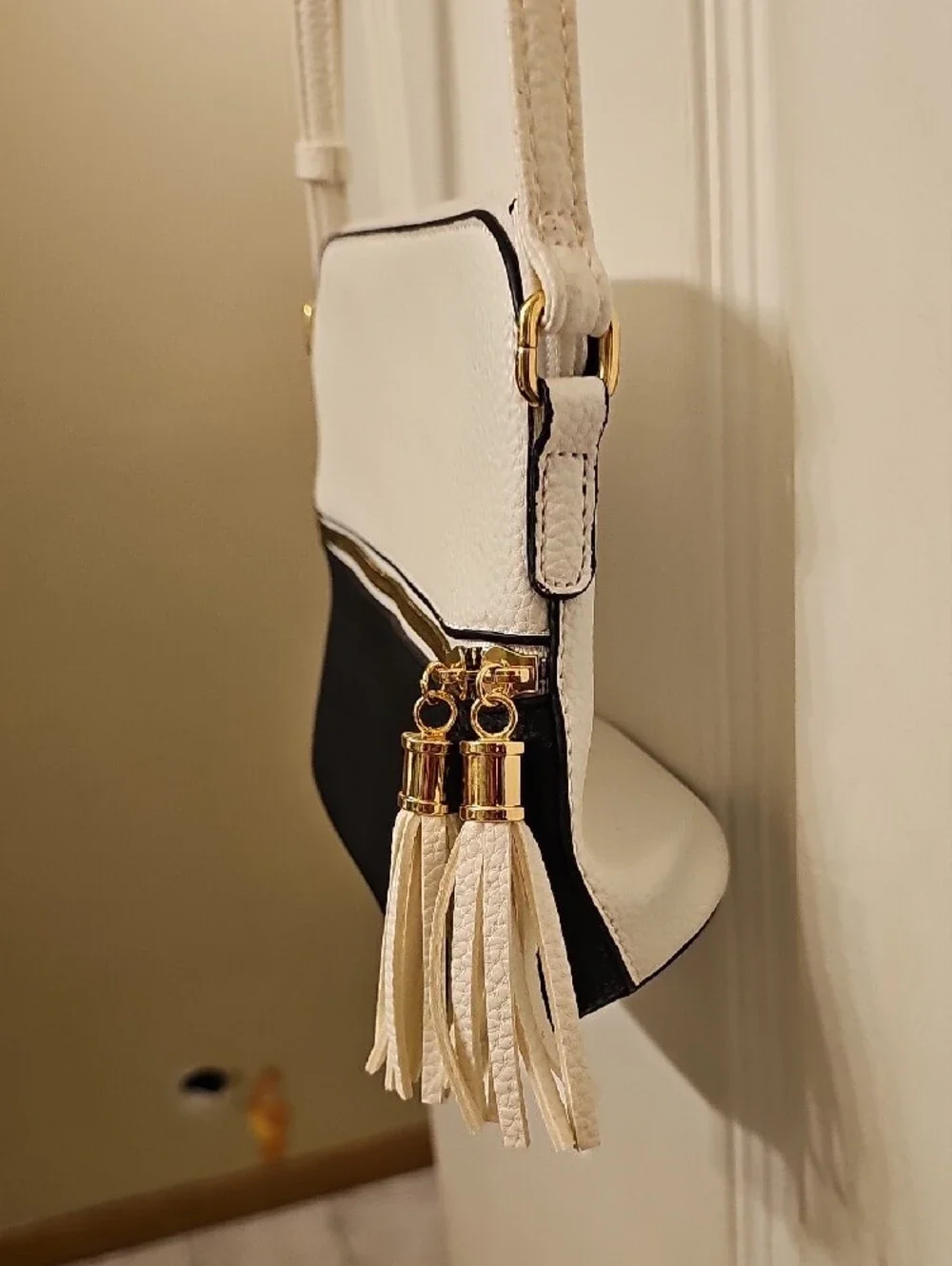 Two-Tone White and Black Crossbody Bag with Tassel Accent